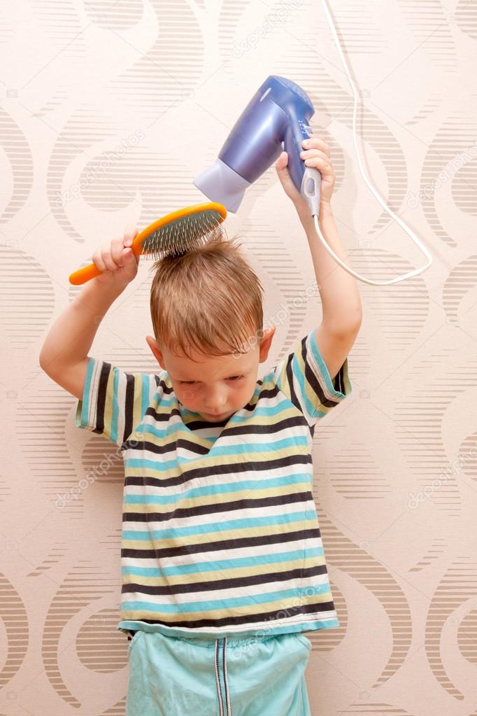 Little boy drying hair with hair dryer. Stock Photo by ©Vitalinka 27131043