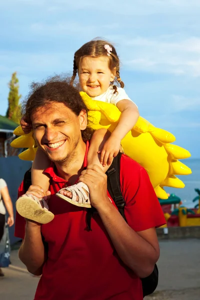 Vader en dochter. Baby zittend op Papa's schouders — Stockfoto