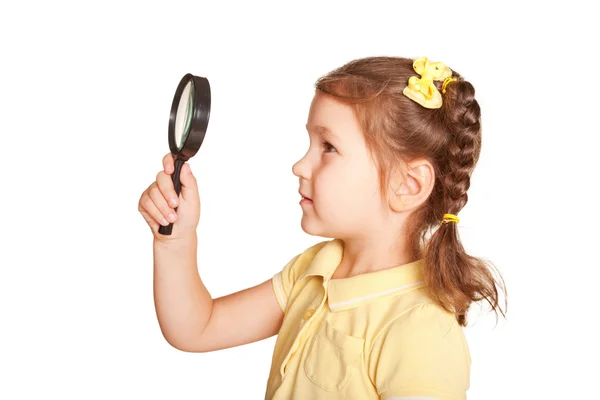 Little girl looking through a magnifying glass — Stock Photo, Image