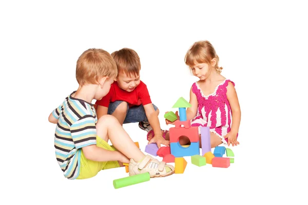 Three children playing and building together. — Stock Photo, Image