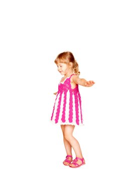 Happy little girl in knitted pink dress dancing. clipart