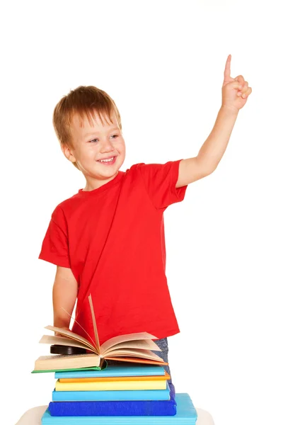 Niño pequeño con libros apuntando hacia arriba —  Fotos de Stock