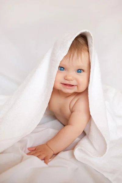 Happy smiling baby with towel on head — Stock Photo, Image