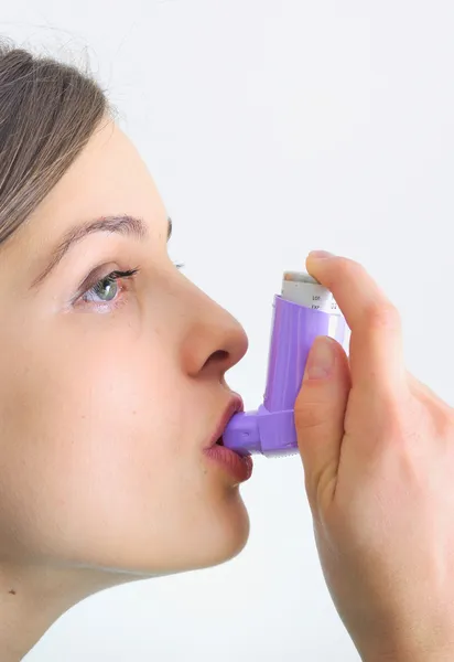 Girl using an inhaler for Asthma — Stock Photo, Image