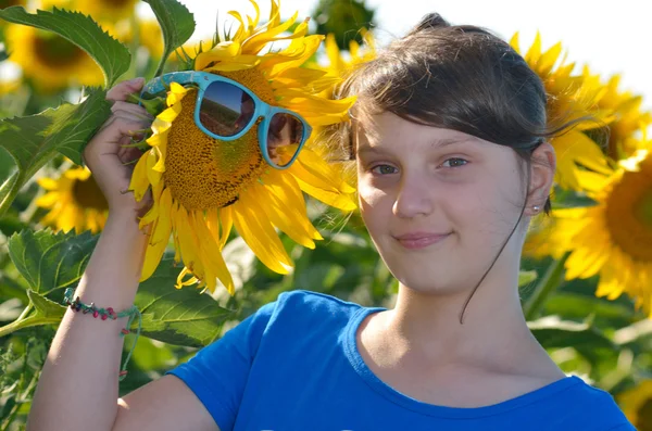 Tineri fată frumoasă într-un câmp de floarea soarelui — Fotografie, imagine de stoc