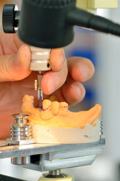 Dental technician measuring dentures — Stock Photo, Image