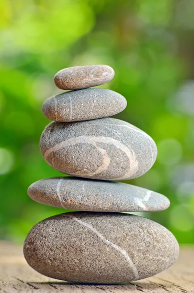 Stack of Stones on a wooden table — Stock Photo, Image