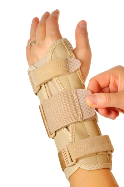 Female wearing wrist brace over white background — Stock Photo, Image