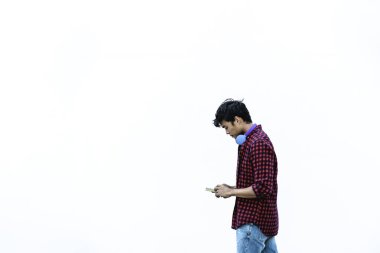 Cep telefonu kullanan Asyalı genç adam - Asyalı sosyal etkenci yeni trendlerle eğleniyor akıllı telefon uygulamaları - Z nesli, medya, teknoloji ve gençlik milenyum insan yaşam tarzı