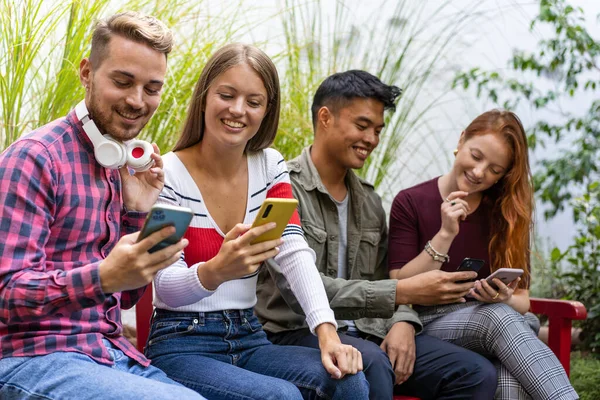 Multikulturní Přátelé Baví Společně Při Pohledu Své Smartphony Dehor Zahradě — Stock fotografie