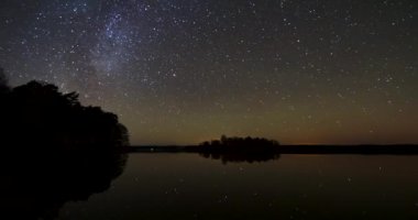 Samanyolu ve kuzey ışıklarıyla zaman ayarlı - Litvanya 'daki göl üzerinde Aurora borealis