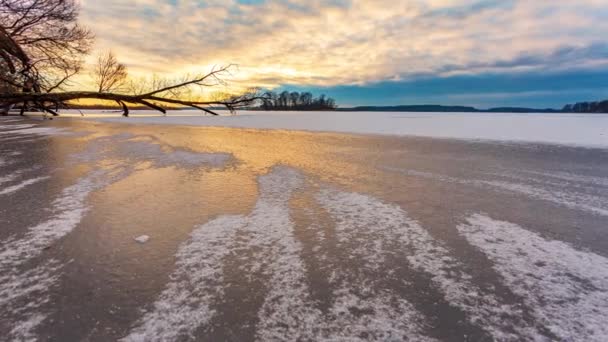 Winter timelapse with clear frozen lake ice and sunset colors, Galve lake, Lithuania, slider shot with winter landscape — Video