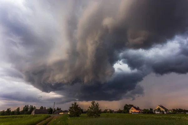 Storm clouds over field, tornadic supercell, extreme weather, dangerous storm in Europe, Lithuania