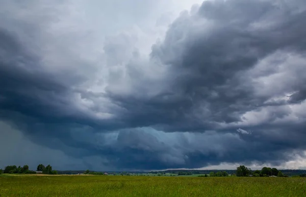 Storm clouds over field, tornadic supercell, extreme weather, dangerous storm in Europe, Lithuania