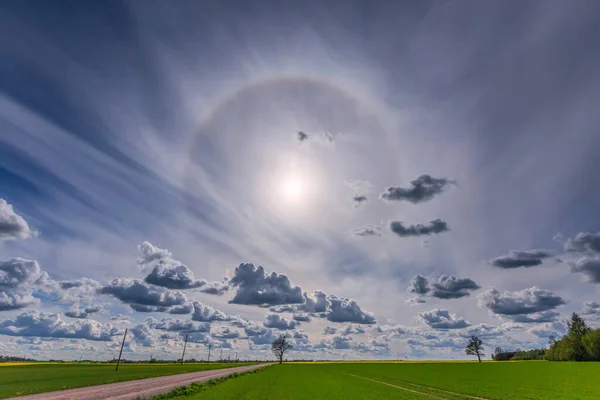 Sun halo is an optical phenomenon that occurs due to sunlight refracting in millions of hexagonal ice crystals suspended in the atmosphe