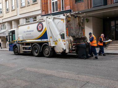 London, UK-11.10.21: A City of Westminster Veolia refuse lorry in central London loading trash bins