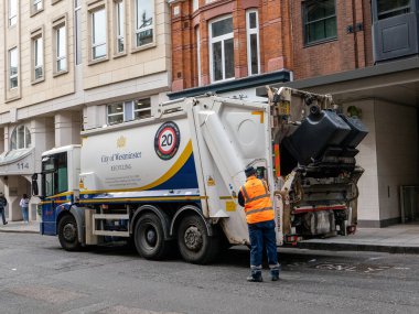 London, UK-11.10.21: A City of Westminster Veolia refuse lorry in central London loading trash bins