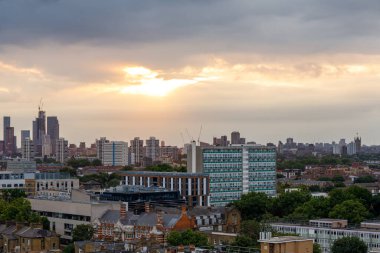A scenic view of South London towards the West as seen from Camberwell before the Sunset on a cloudy summer day. Vauxhall is on the left; House of Parliament on the right