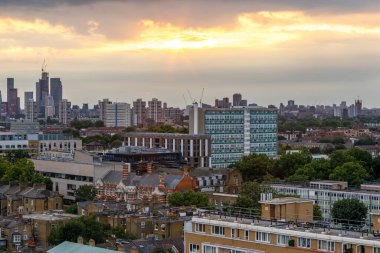 A scenic view of South London towards the West as seen from Camberwell before the Sunset on a cloudy summer day. Vauxhall is on the left; House of Parliament on the right