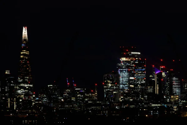 Scenic view of the City of London and the Shard at night as seen from the South. The City is the primary central business district of London and the world