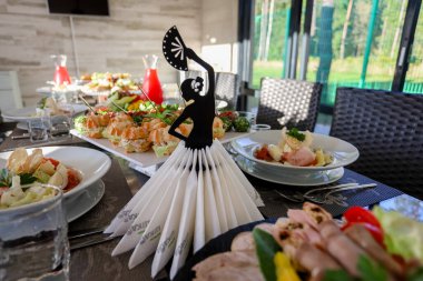 Yemek masası, peçete tutacağı, tabakta yemek.