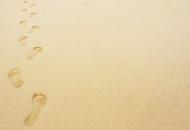 Footprints in the sand background clipart