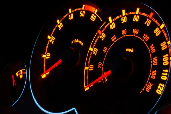 Backlit car dashboard dials glowing at night — Stock Photo, Image