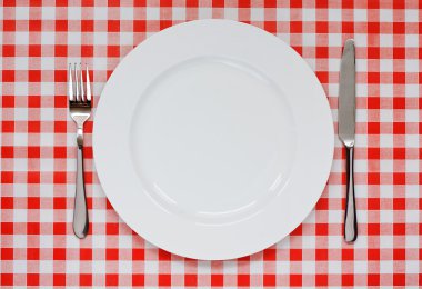 Place setting on red Gingham tablecoth clipart