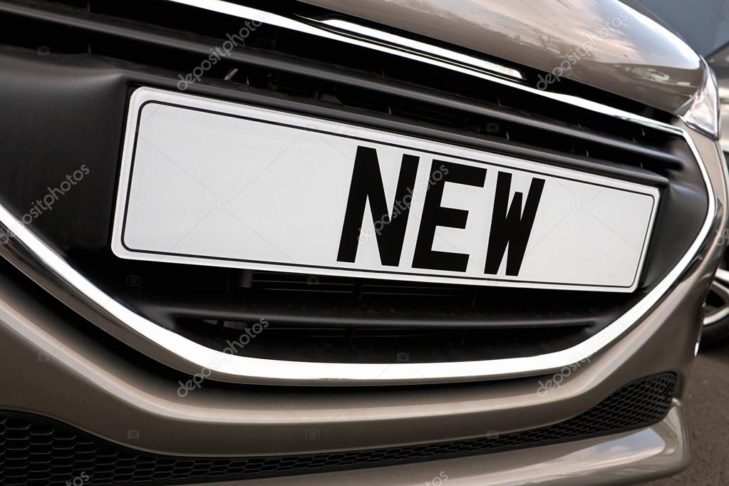 Number plate of a new car for retail sale on a motor dealers forecourt all logos removed