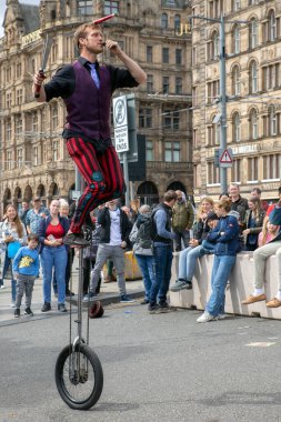 Edinburgh Festival Fringe 2022- 5 Aug-29 Aug, Edinburgh UK. events to mark its 75th anniversary. Performers  on the street. Actors of street theater and musicians in capitol of Scotland. The artist on a on one wheel bicycle.