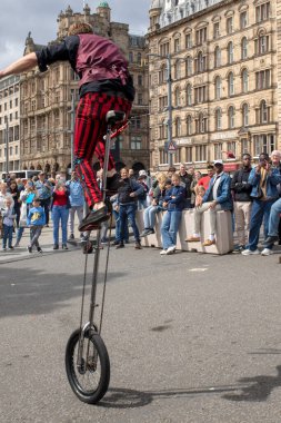 Edinburgh Festival Fringe 2022- 5 Aug-29 Aug, Edinburgh UK. events to mark its 75th anniversary. Performers  on the street. Actors of street theater and musicians in capitol of Scotland. The artist on a on one wheel bicycle.