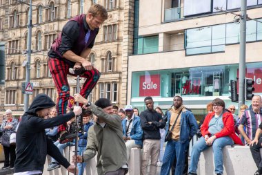Edinburgh Festival Fringe 2022- 5 Aug-29 Aug, Edinburgh UK. events to mark its 75th anniversary. Performers  on the street. Actors of street theater and musicians in capitol of Scotland. The artist on a on one wheel bicycle.