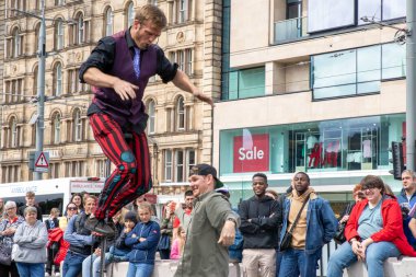 Edinburgh Festival Fringe 2022- 5 Aug-29 Aug, Edinburgh UK. events to mark its 75th anniversary. Performers  on the street. Actors of street theater and musicians in capitol of Scotland. The artist on a on one wheel bicycle.