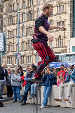 Edinburgh Festival Fringe 2022- 5 Aug-29 Aug, Edinburgh UK. events to mark its 75th anniversary. Performers  on the street. Actors of street theater and musicians in capitol of Scotland. The artist on a on one wheel bicycle.
