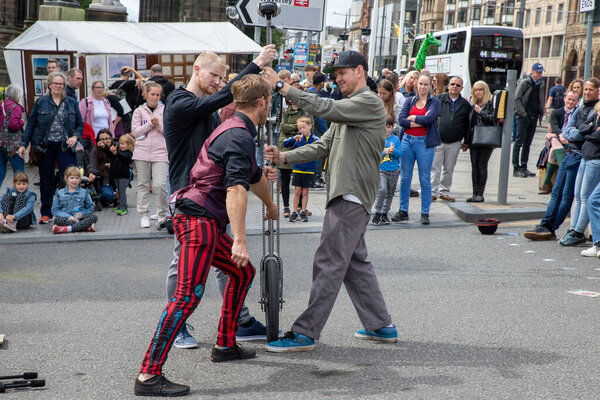 Edinburgh Festival Fringe 2022- 5 Aug-29 Aug, Edinburgh UK. events to mark its 75th anniversary. Performers  on the street. Actors of street theater and musicians in capitol of Scotland. The artist on a on one wheel bicycle.