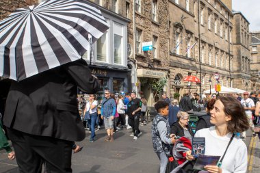 Edinburgh Festival Fringe 2022-5 Aug-29 AugLocation: Edinburgh UK. Performers  on the street. Actors of street theater and musicians in capitol of Scotland.People advertising a theatrical performance clipart