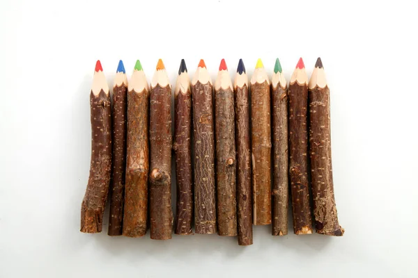 colourful pencils natural wood on white background studio sharp tip top view