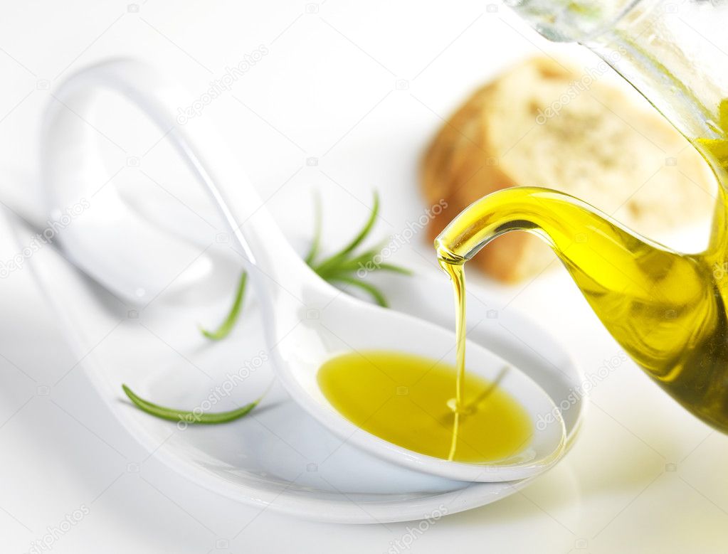 virgin olive oil pouring in a spoon