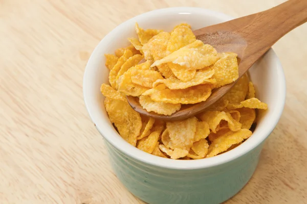 Corn flakes in wooden spoon — Stock Photo, Image