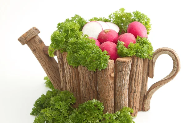 Fresh radishes with pasley in wooden pot — Stock Photo, Image