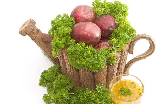 Passion fruit juice with pasley,in the wooden pot — Stock Photo, Image