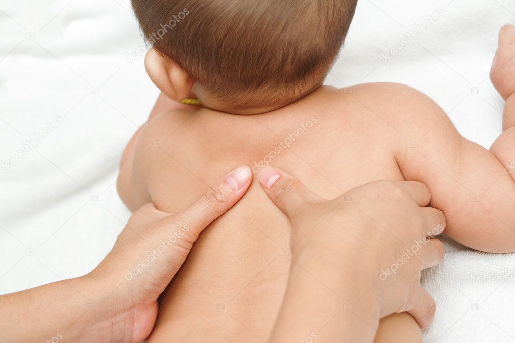 Mother hand massaging back muscle of her baby,touch of Happines