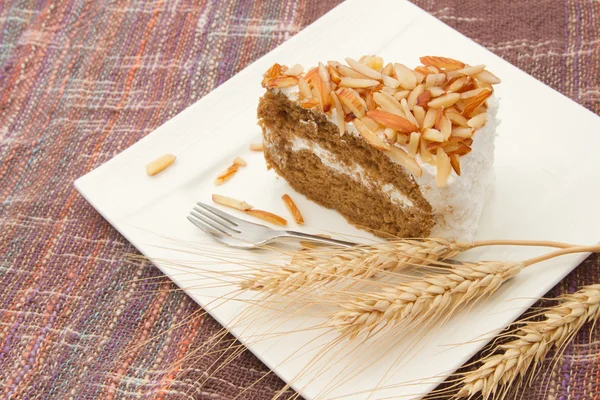 Coffee almond cake on white dish — Stock Photo, Image
