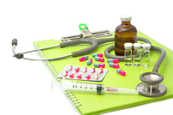 Ampules médicales, pilules et seringues, stéthoscope sur dossier médical — Photo