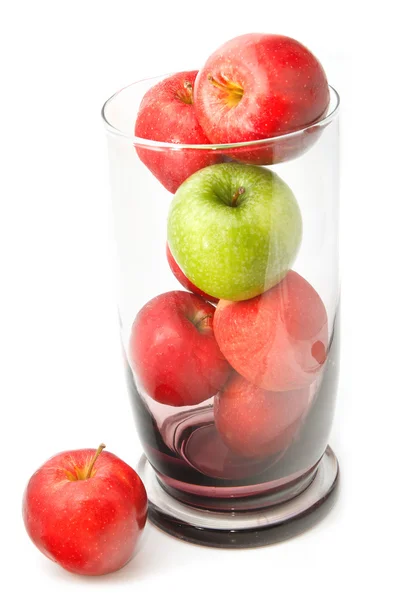 Green apple on red apple in glass jar — Stock Photo, Image
