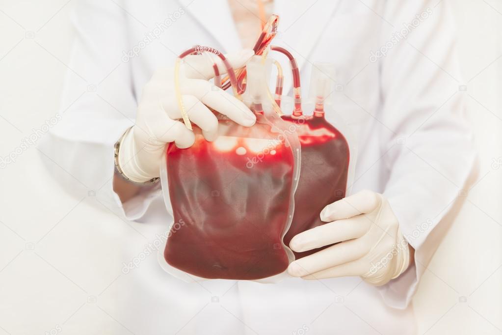 Doctor holding fresh donor blood for transfusion