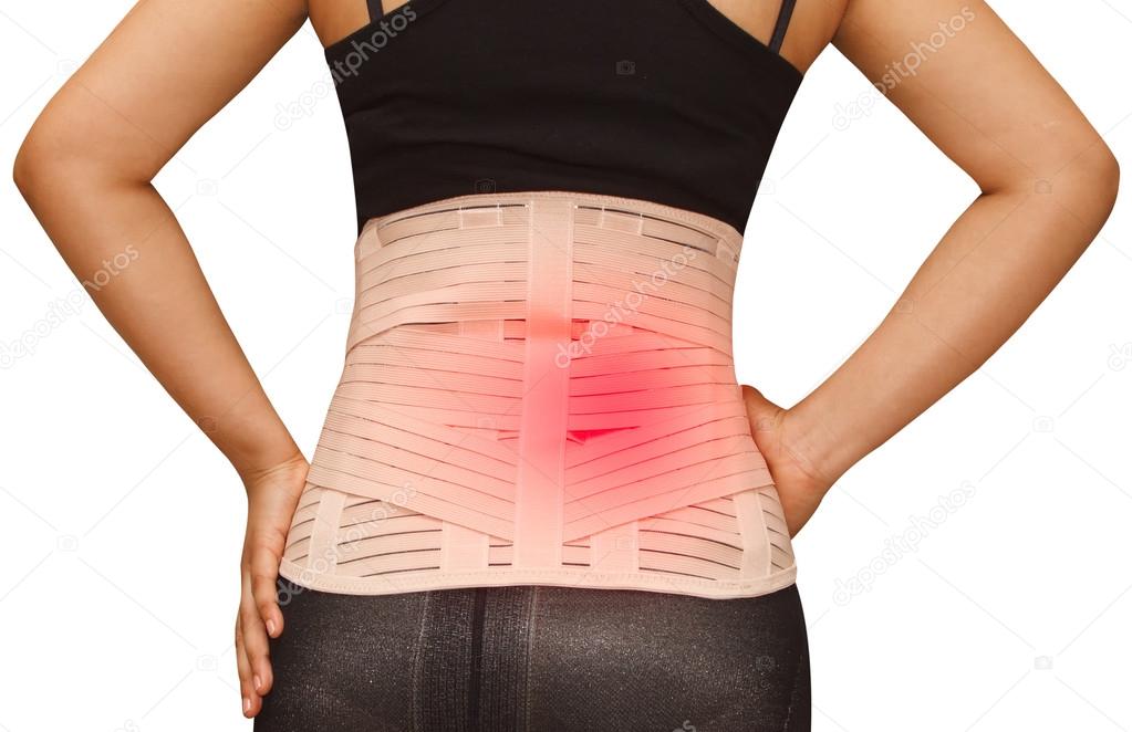 Woman in pain from back injury wearing lumbar brace corset