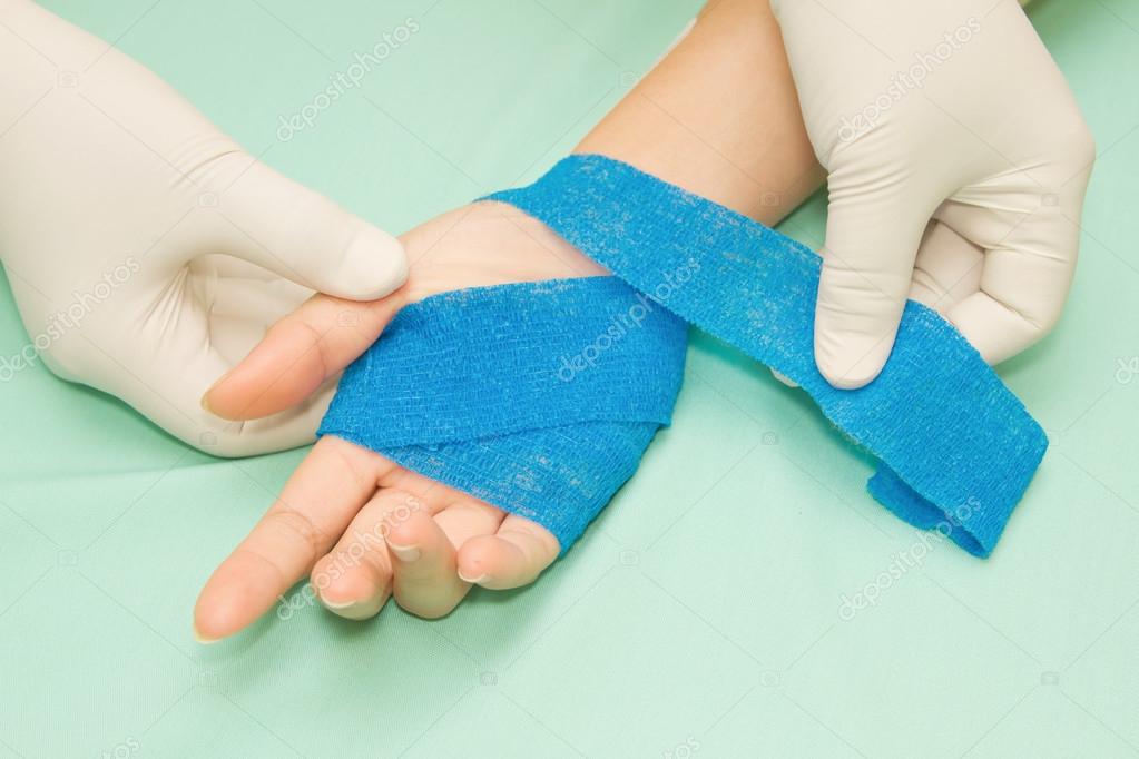 Wound dressing appy medicine bandage on hand injury Stock Photo by