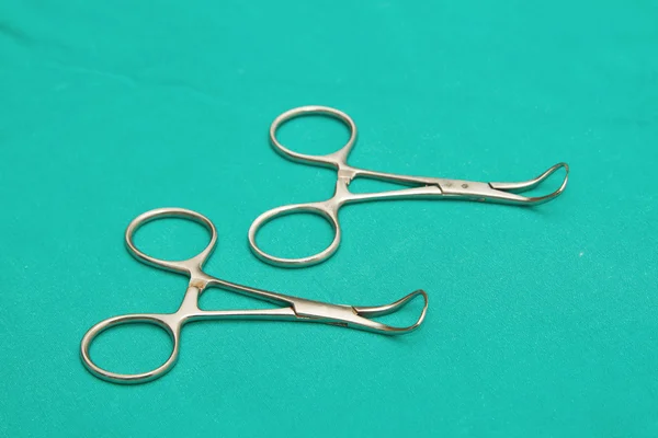 Surgical pliers on sterile table — Stock Photo, Image