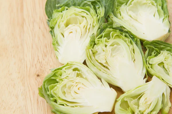 Choux de Bruxelles tranchés sur la table en bois blanc — Photo